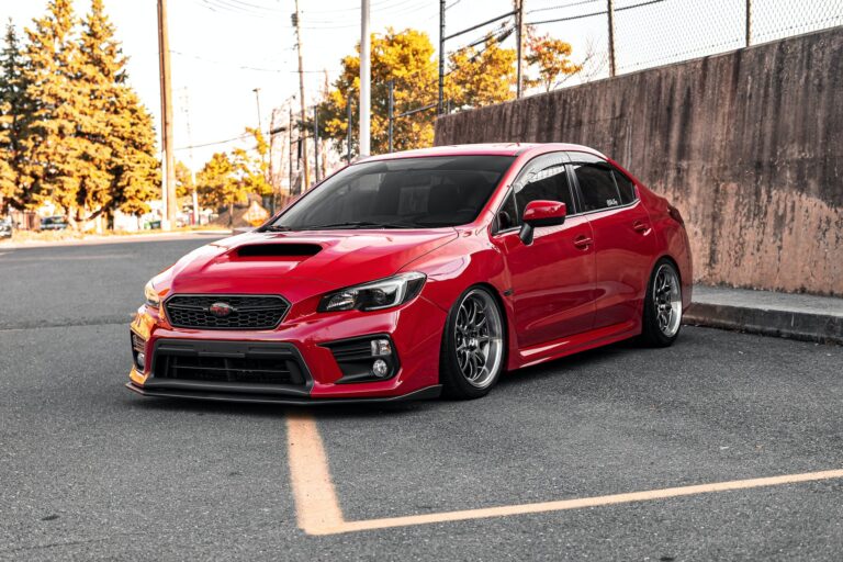 red subaru sedan on road